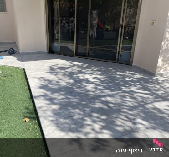 ריצוף חדש ליד דלת זכוכית בחצר